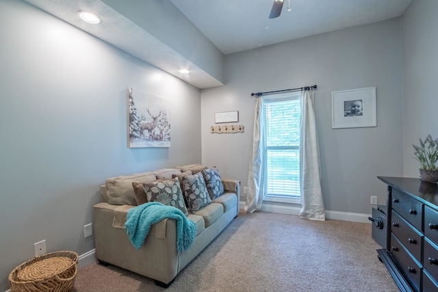 carpeted living room with ceiling fan