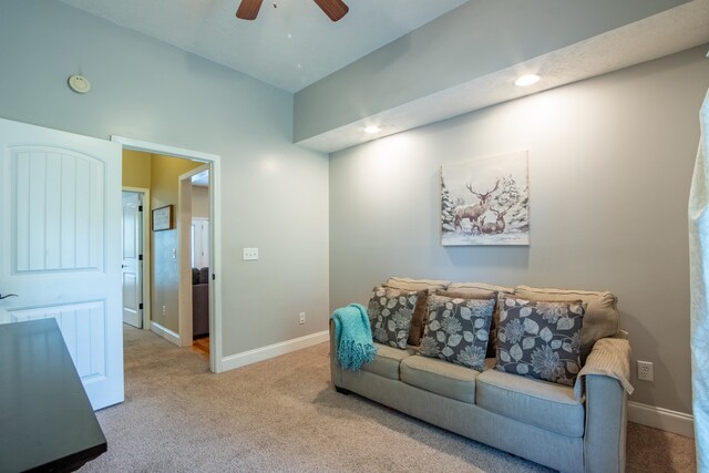 living room with ceiling fan and carpet