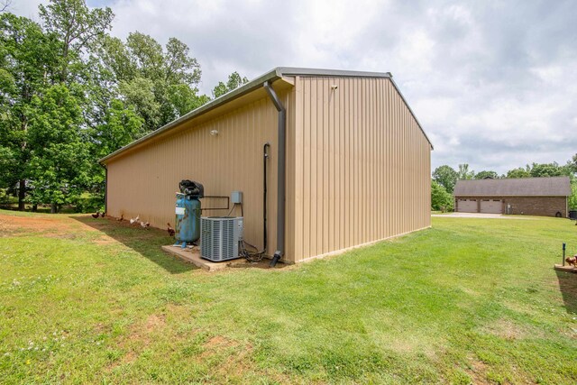 exterior space with a yard and central air condition unit