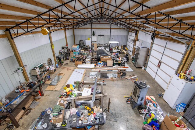 garage with white refrigerator and a workshop area