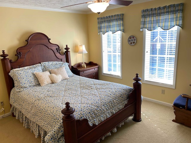 carpeted bedroom with ceiling fan, a textured ceiling, and crown molding