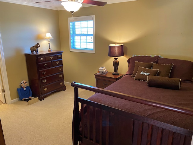 carpeted bedroom with ceiling fan and crown molding