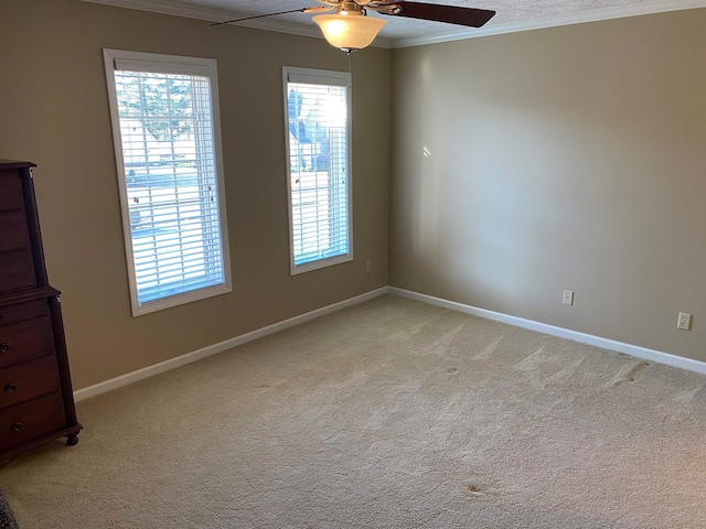 interior space with a healthy amount of sunlight, ornamental molding, carpet flooring, and ceiling fan