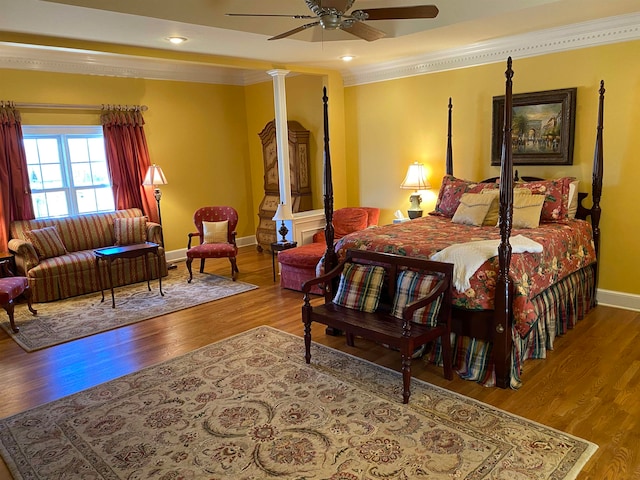 bedroom featuring crown molding, ornate columns, wood-type flooring, and ceiling fan