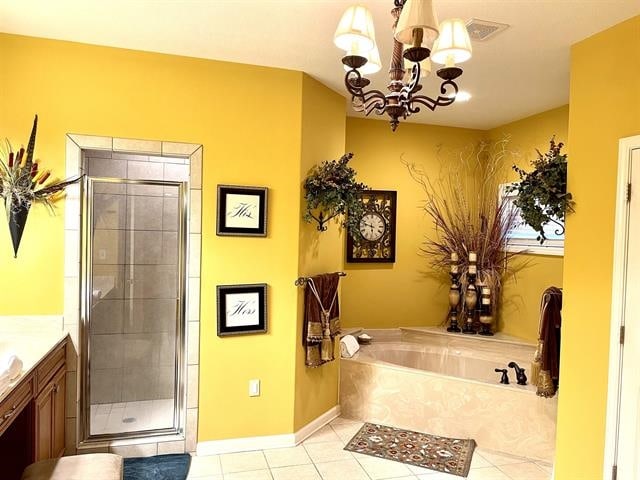 bathroom featuring tile patterned floors, a notable chandelier, independent shower and bath, and vanity