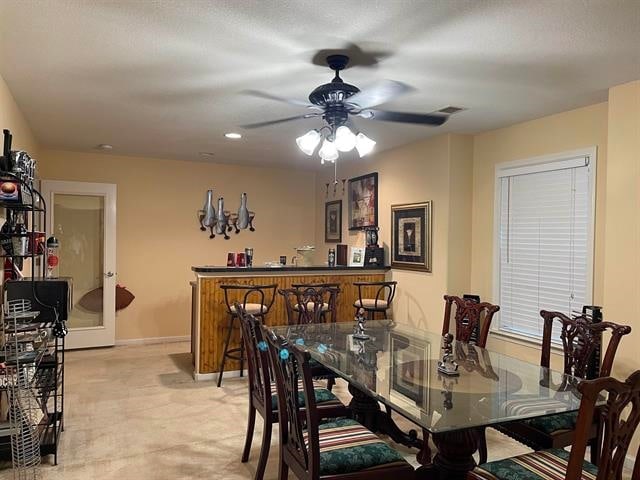 carpeted dining area featuring ceiling fan