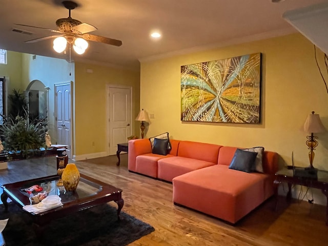 living room featuring hardwood / wood-style floors, crown molding, and ceiling fan