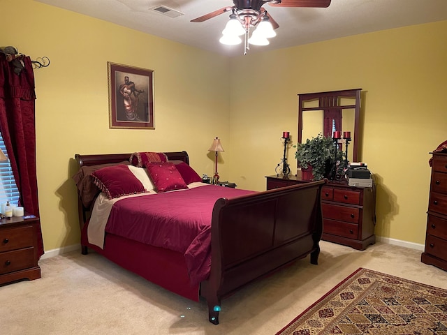 bedroom with ceiling fan and light carpet