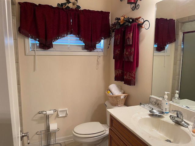 bathroom with vanity, walk in shower, and toilet