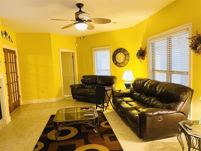 tiled living room featuring ceiling fan