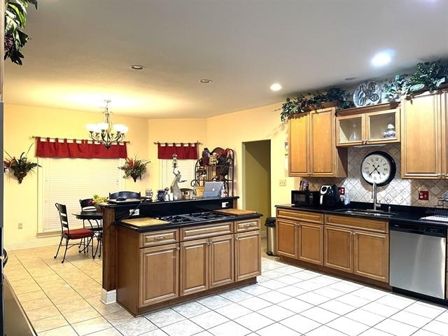 kitchen with light tile patterned flooring, sink, decorative backsplash, a chandelier, and dishwasher