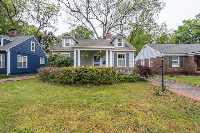 new england style home with a front lawn