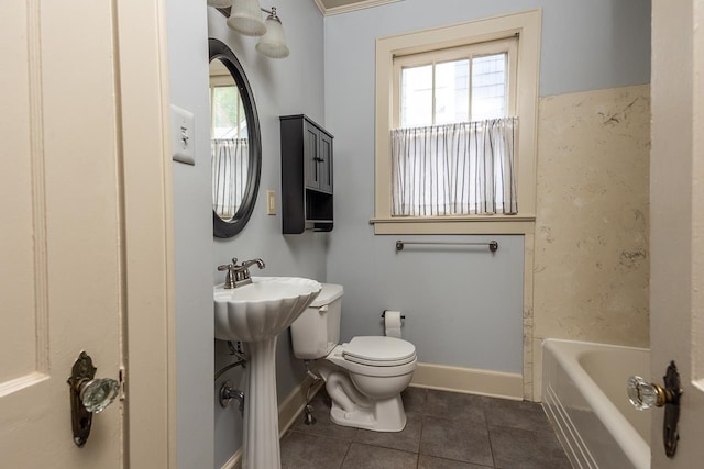 bathroom with crown molding, toilet, tile floors, and bathing tub / shower combination