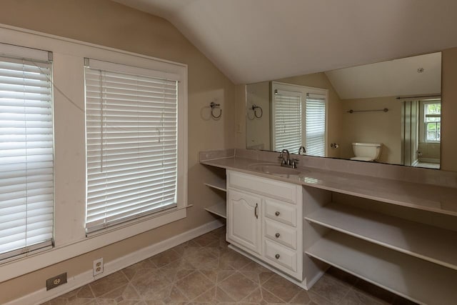 bathroom with tile floors, vaulted ceiling, toilet, and vanity