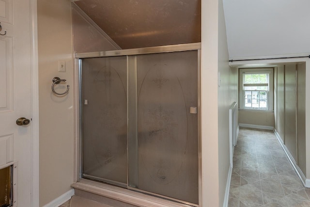 bathroom featuring walk in shower and tile flooring