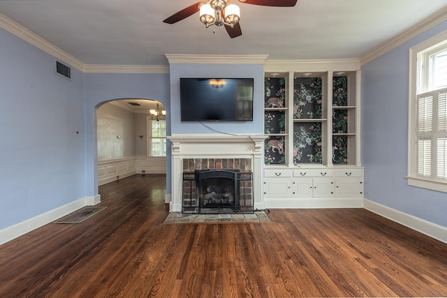 unfurnished living room with ceiling fan, dark wood-type flooring, and ornamental molding