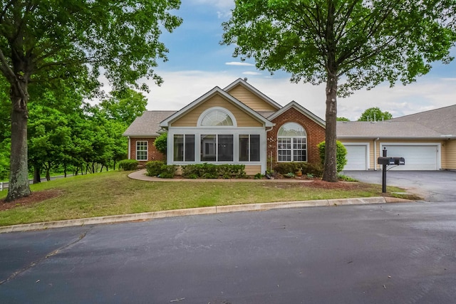 view of front facade with a garage and a front lawn