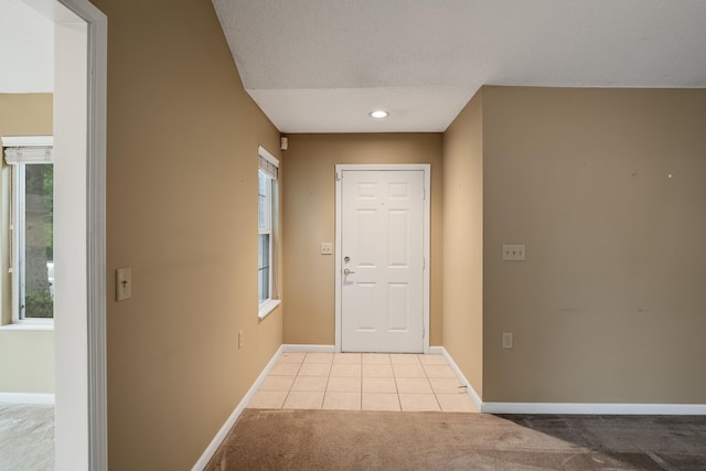 doorway to outside with light tile floors