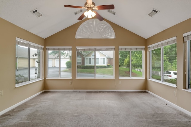 unfurnished sunroom featuring vaulted ceiling, ceiling fan, and a healthy amount of sunlight