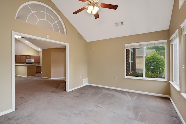 carpeted empty room with lofted ceiling and ceiling fan