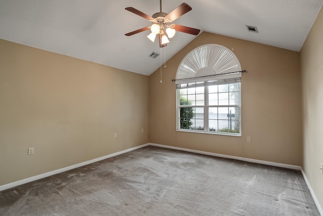 carpeted empty room with lofted ceiling and ceiling fan