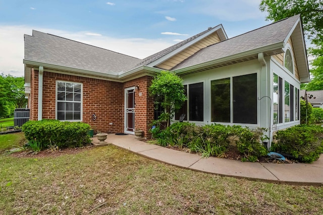 single story home with a front yard and central AC unit