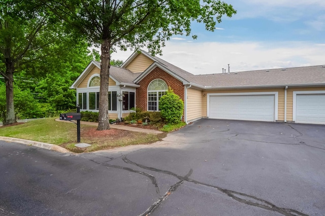 view of front of home with a front lawn and a garage