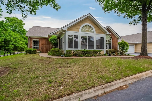 ranch-style house featuring a front yard and a garage