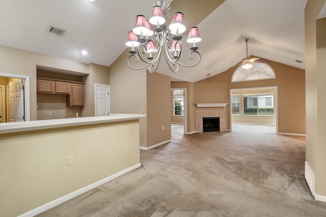 unfurnished living room with light colored carpet, plenty of natural light, and a fireplace