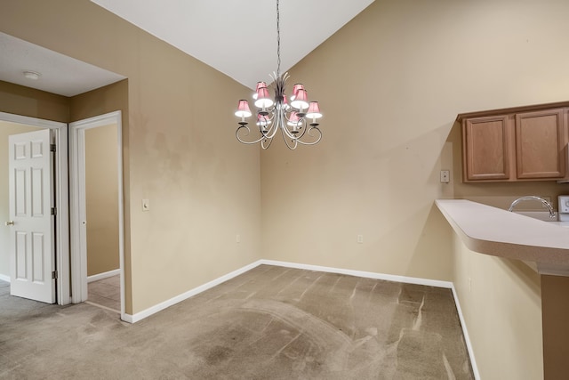 unfurnished dining area with an inviting chandelier, carpet flooring, sink, and lofted ceiling