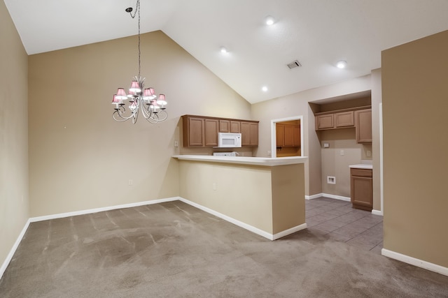 kitchen with high vaulted ceiling, decorative light fixtures, carpet flooring, a chandelier, and kitchen peninsula