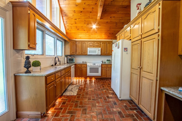 kitchen featuring light stone countertops, white appliances, lofted ceiling with beams, wood ceiling, and sink