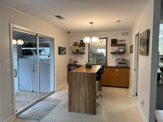 interior space featuring an inviting chandelier and crown molding