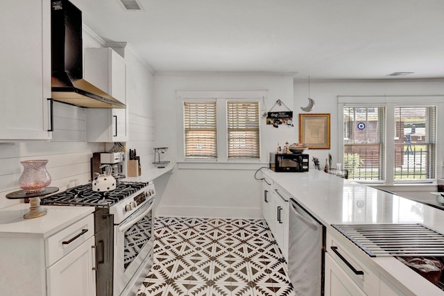 kitchen with wall chimney exhaust hood, stainless steel appliances, a healthy amount of sunlight, and tasteful backsplash