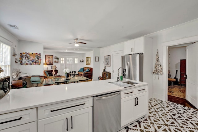 kitchen with ceiling fan, sink, light hardwood / wood-style flooring, white cabinetry, and appliances with stainless steel finishes