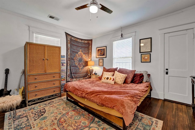 bedroom featuring ceiling fan, crown molding, and dark wood-type flooring