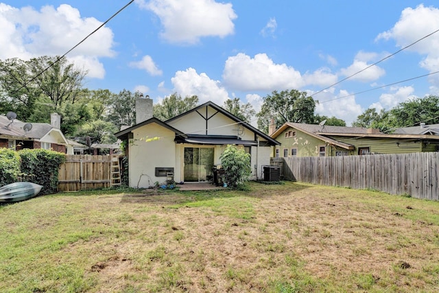 back of property with cooling unit, a patio area, and a yard