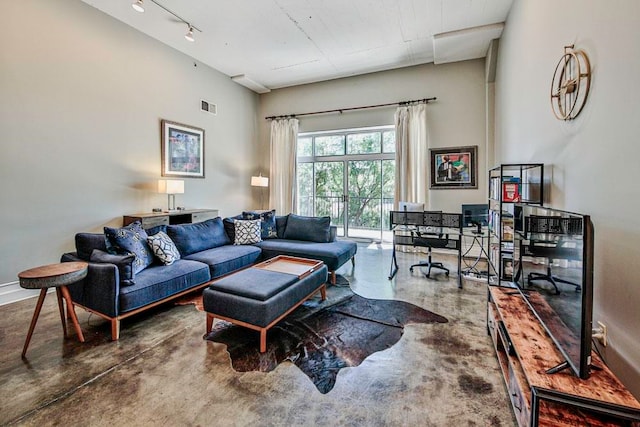 living room with concrete floors and track lighting