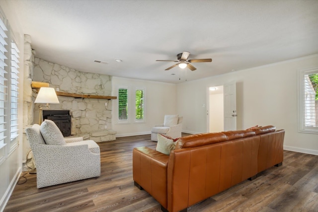 living room with ceiling fan, a healthy amount of sunlight, a fireplace, and wood-type flooring