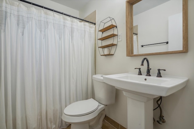 bathroom with tile flooring and toilet