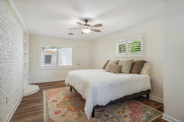 bedroom with ornamental molding, ceiling fan, dark hardwood / wood-style floors, and multiple windows