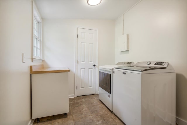 washroom featuring washing machine and clothes dryer and light tile flooring