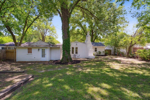 back of property with a lawn