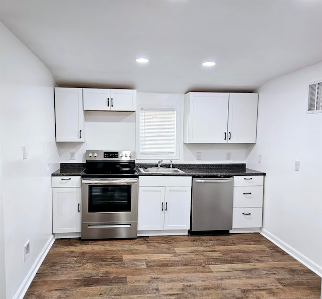 5907 Old Millington Rd, Millington, TN 38053 - kitchen with white cabinets, sink, stainless steel appliances, and dark wood-type flooring