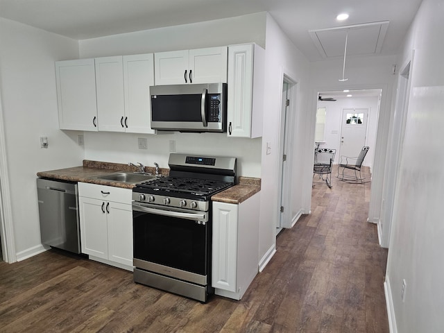 5907 Old Millington Rd, Millington, TN 38053 - kitchen featuring white cabinets, stainless steel appliances, dark wood-type flooring, and sink