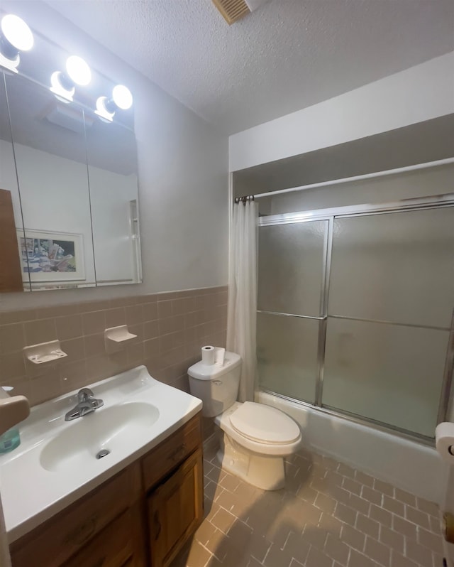 full bathroom featuring tile flooring, a textured ceiling, tile walls, tasteful backsplash, and toilet