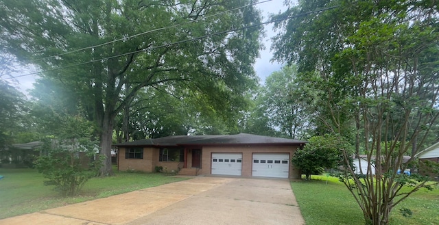 view of front of house featuring a garage and a front lawn