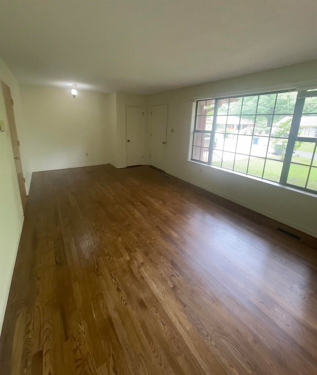 unfurnished room featuring dark hardwood / wood-style flooring