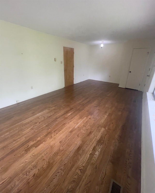 empty room with hardwood / wood-style floors