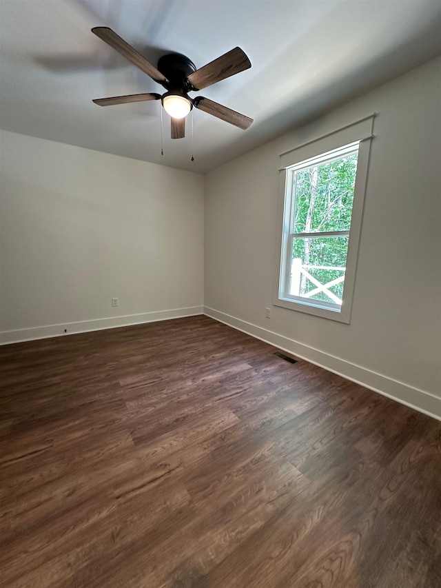 unfurnished room with ceiling fan and dark hardwood / wood-style flooring